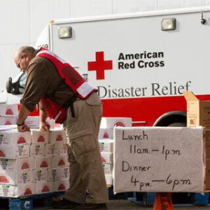 Red Cross van with man unloading supplies