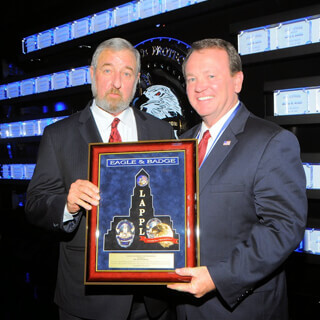 Men holding Plaque