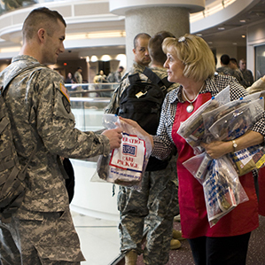 woman giving soldier a care package