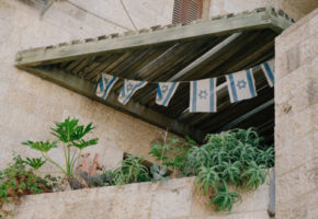wooden rooftop decorated with Israel flags